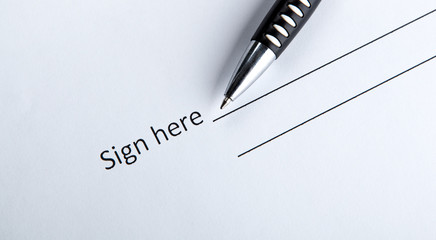 One document with a place for a signature and a pen