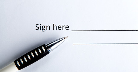 One document with a place for a signature and a pen