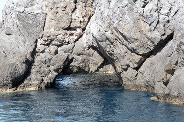 A stunning natural passageway in a cliff-face along Marina di Camerota coastline, Italy