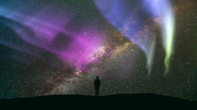 The man standing against a meteor shower with a northern light. time lapse