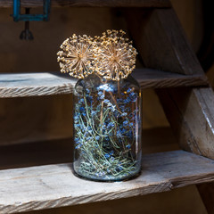 A decorative jar with dry flowers