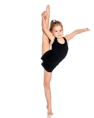 The gymnast balances on one leg.