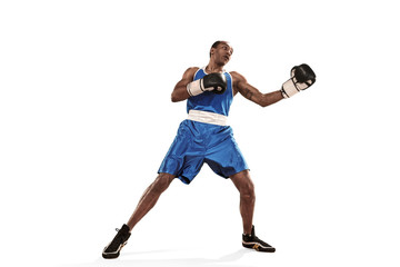 Sporty man during boxing exercise making hit. Photo of boxer on white background
