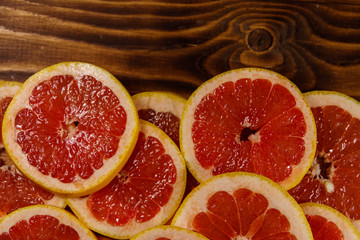 Sliced grapefruits on wooden table. Top view, copy space