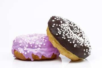 .Sweet donuts in chocolate and lavender glaze on a white background. Copy space