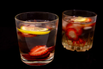 lemonade with strawberries on black background