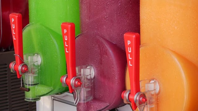 Freezing and mixing machine for the production of cold ice slush fruit juice. Different flavors in many colors.
