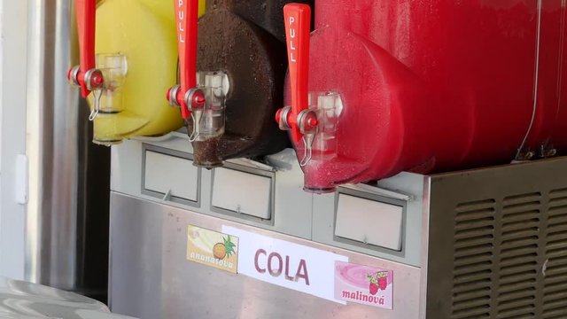 Freezing and mixing machine for the production of cold ice slush fruit juice. Different flavors in many colors.