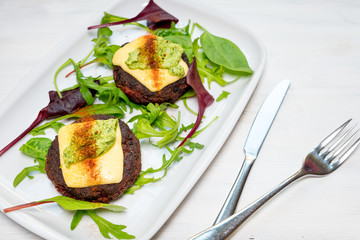 Healthy vegetarian potato patties with carrots, broccoli, bell pepper, green peas and onions with roque and basil sauce.