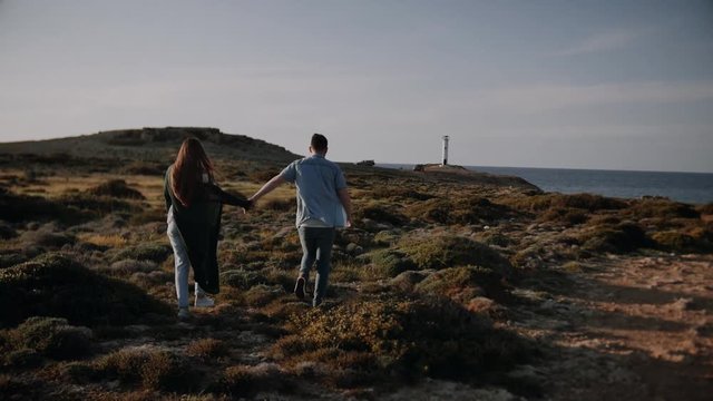 beautiful couple love each other in front of a lighthouse