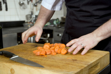 Obraz na płótnie Canvas Professional chef at work in a restaurant kitchen
