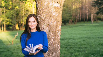 Girl reading book in park