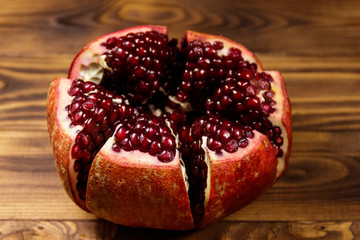 Ripe pomegranate fruit on wooden table