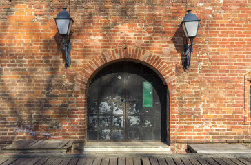 Old iron gate in brick wall