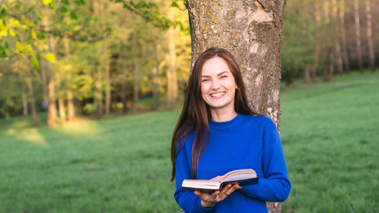 Girl reading book in park