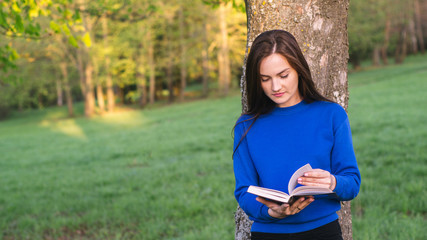 Girl reading book in park
