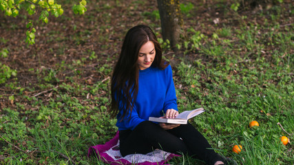 Girl reading book in park