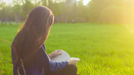 Girl reading book in park