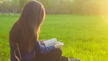 Girl reading book in park