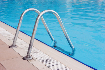 blue swimming pool with steel ladder