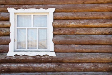 Carved window of an old wooden farmhouse. Copy space