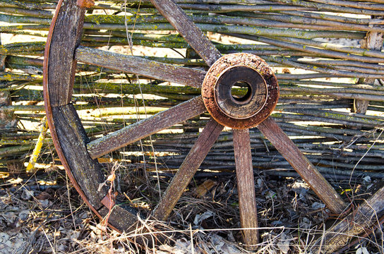 Old wooden cart wheel. The concept of outdated technologies, ecotourism
