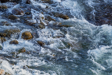 Raging water in threshold of the mountain river