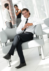 smiling businessman sitting in office chair