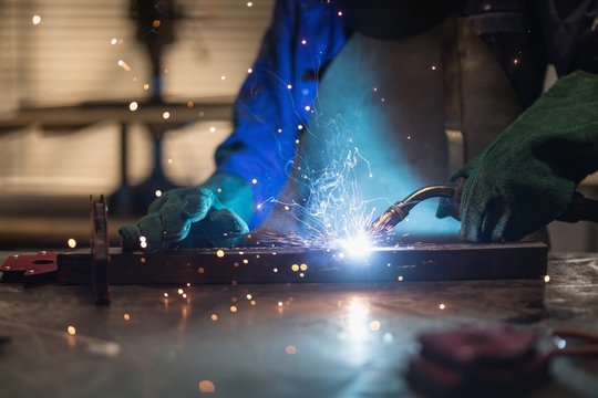 Female welder using welding torch