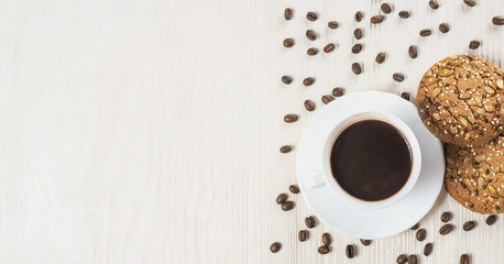 Cup of hot chocolate and Homemade cookies with seeds on white wooden background