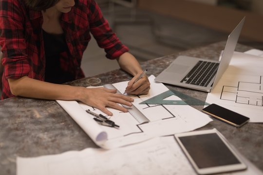 Female welder working in workshop - Powered by Adobe