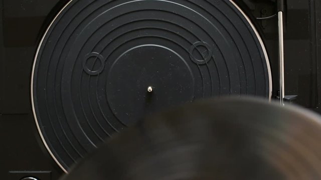 Close up of hands change vinyl record on turntable