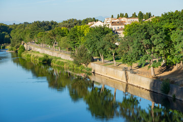 View of walkway on the river Aude in the town of Carcassonne, France