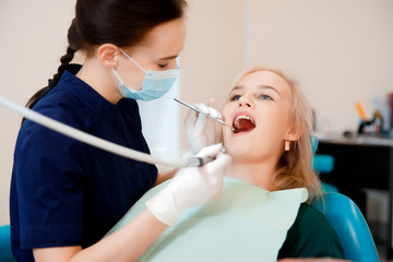 Student trainee medical dentist conducts an examination of female patient.