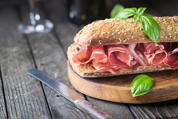 Sandwich with jamon serrano and basil