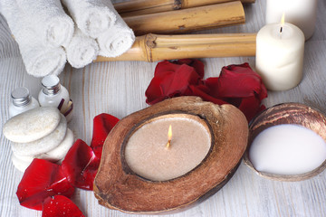 Still life with a set for a spa, candles, towels and coconut milk