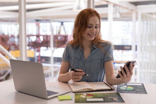 Businesswoman using smartphone in office