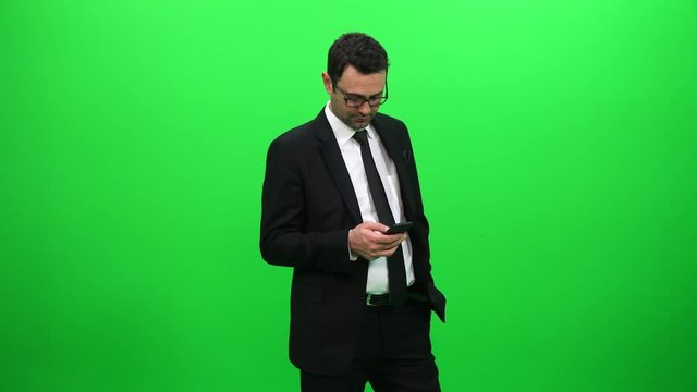Businessman Using Mobile Phone on Green Screen