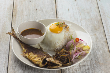 fried fish with rice with spices and curry