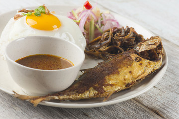 fried fish with rice with spices and curry