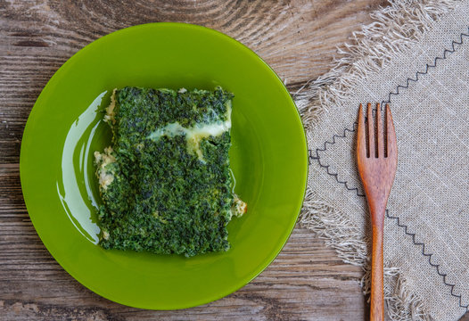 scrambled eggs with spinach on a green plate