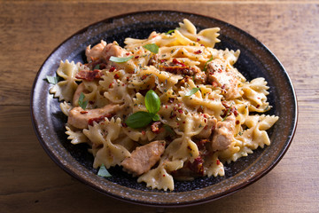 Sun dried tomato pasta with chicken and basil in creamy mozzarella sauce