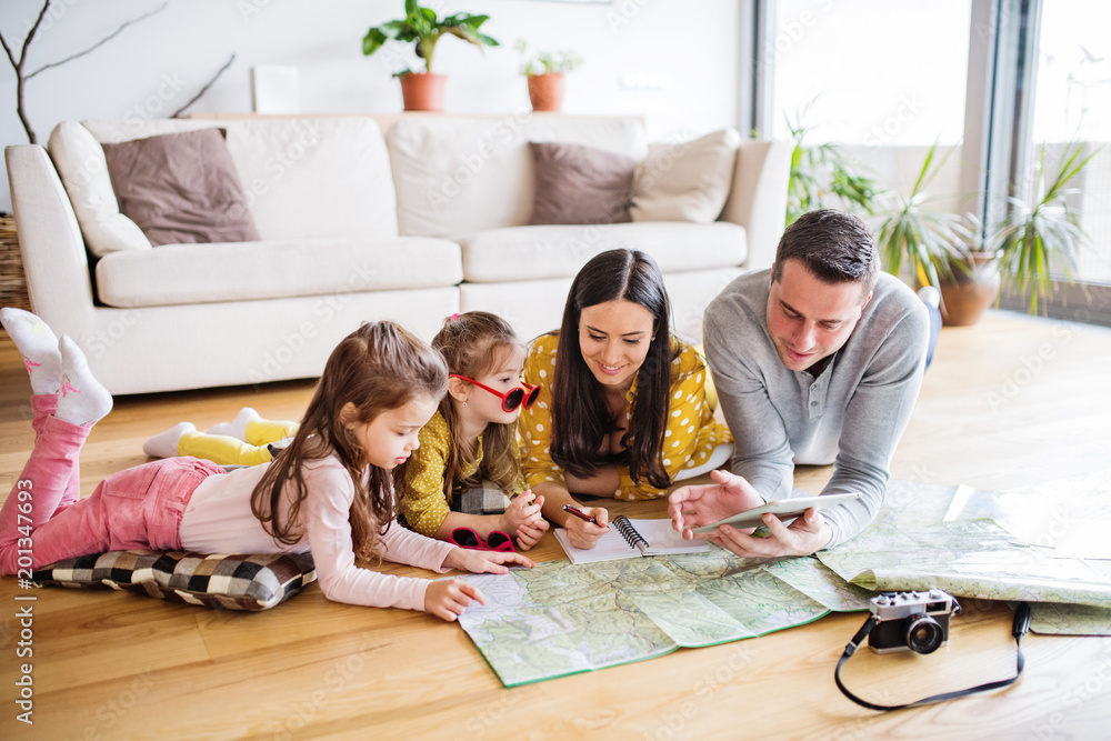 Wall mural young family with two children preparing for holidays.