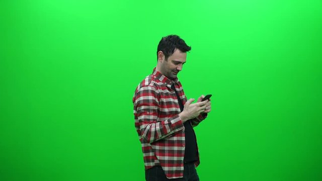 Man Taking A Selfie Photo With His Smartphone On A Green Screen