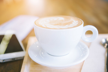 cup of coffee tablet and smart phone on wooden table
