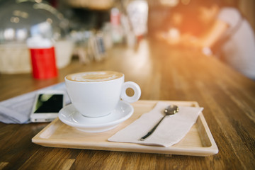 cup of coffee tablet and smart phone on wooden table