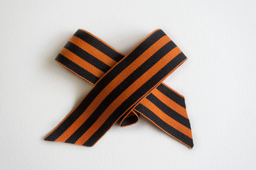 Saint George ribbon with order of the Great Patriotic and red carnations on gray