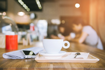 cup of coffee tablet and smart phone on wooden table