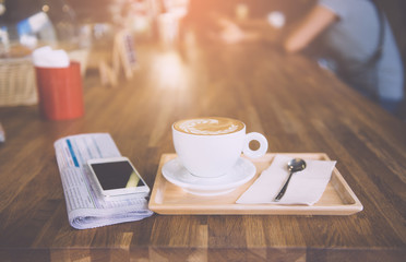 cup of coffee tablet and smart phone on wooden table