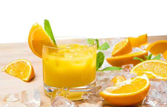 Mixture of sliced fresh citrus fruits, orange, lime, lemon and kumquat for squeezing juice on ice and wooden table